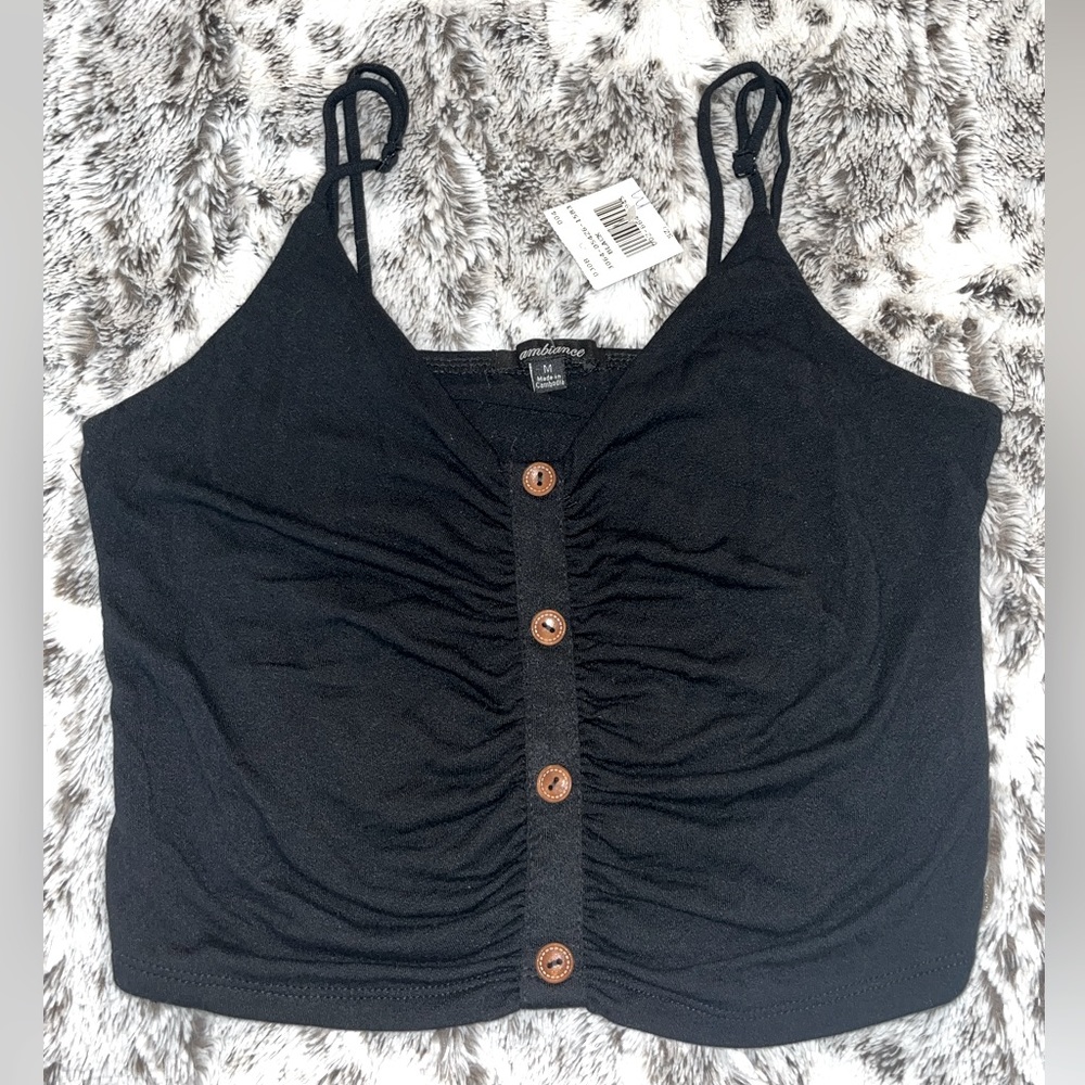 black tank top with brown button’s going down the middle